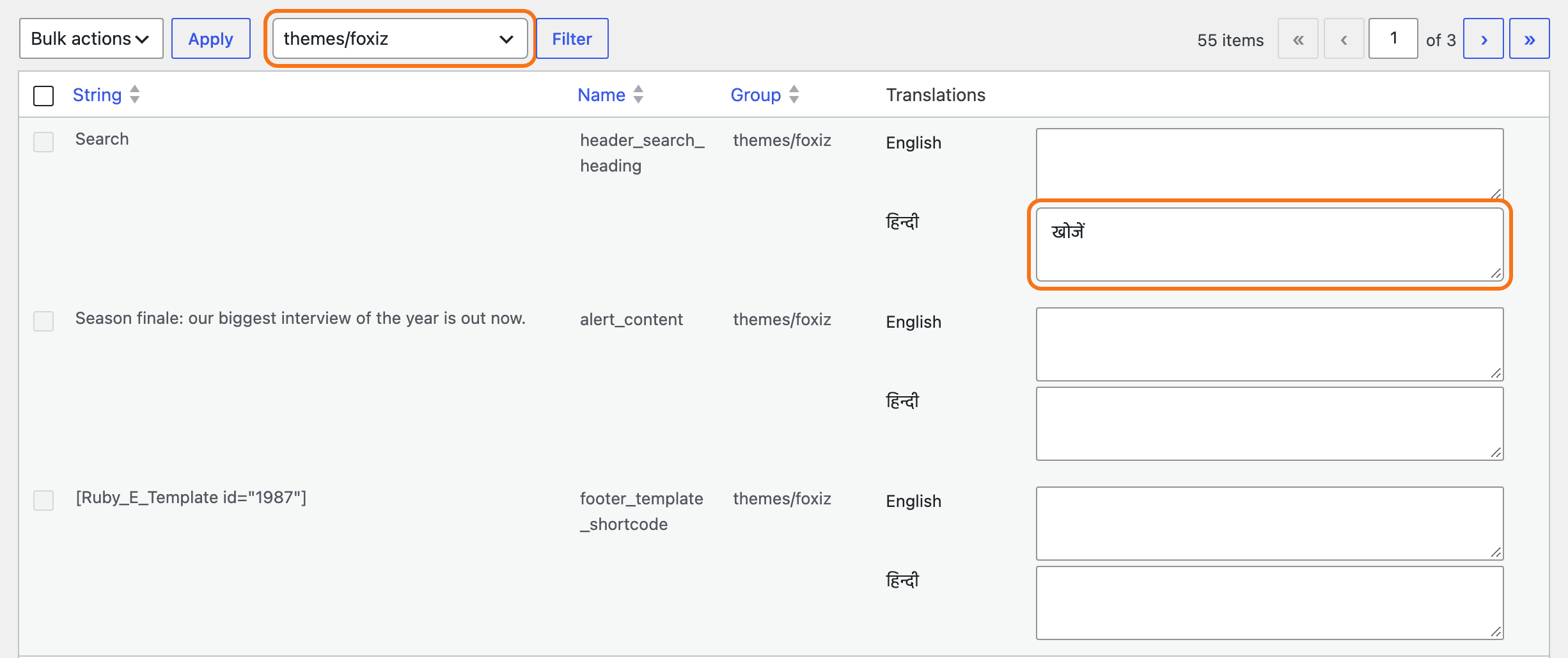 Languages > Translations filtered to the themes/foxiz group: the Foxiz header search heading, alert bar text and footer template shortcode from Theme Options, each with an English and a हिन्दी box, खोजें typed in for Search, outlined in orange