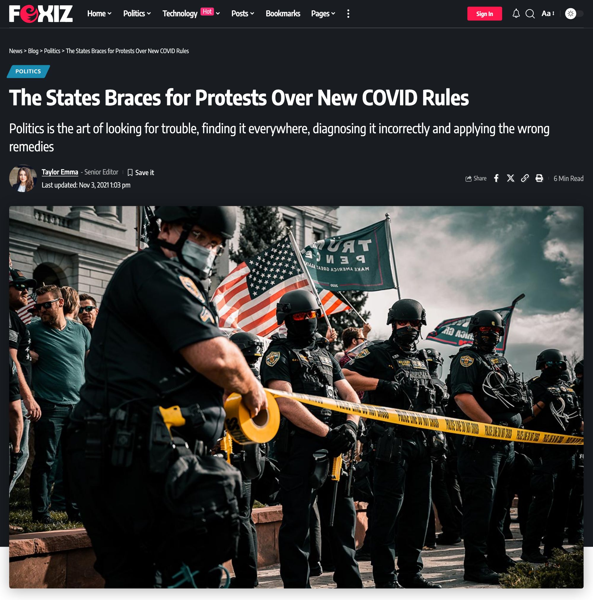The top of a single post on the Default demo in Layout 2: the Politics label, title, tagline and meta bar, then a featured image spanning the whole container width above the content and sidebar